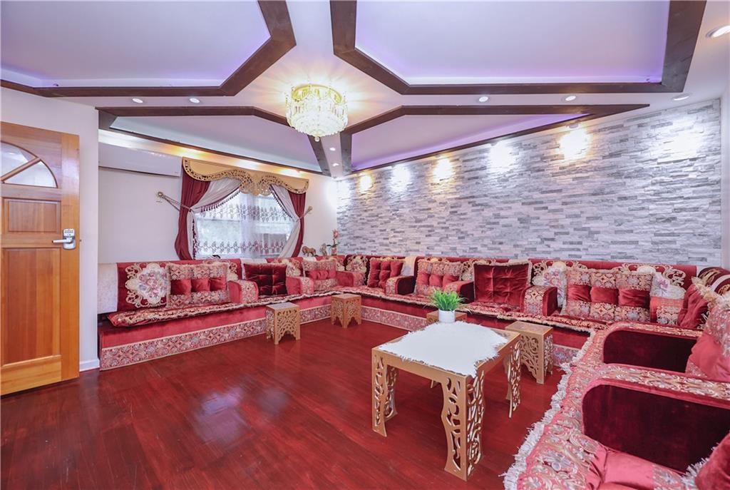 8844 18th Avenue Brooklyn, NY 11214 - Photo 8 of 19 a living room with lots of furniture and a large window