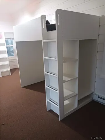 a view of a room with wooden floor and a window