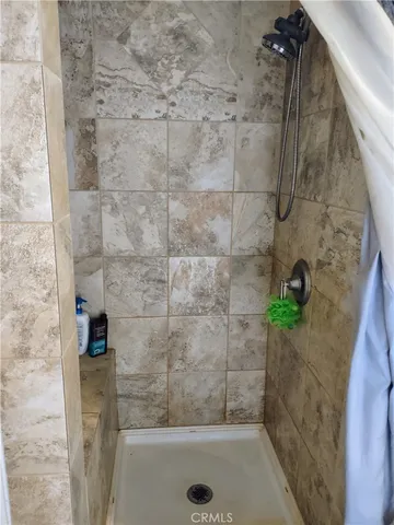 a view of a house with a red door and a porch