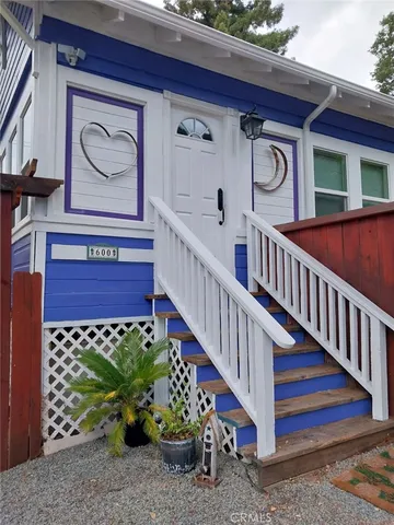 a view of a house with a sitting area and garden