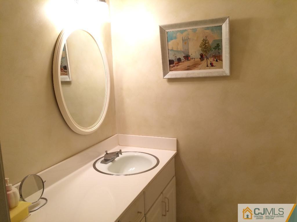 10 Carpender Road New Brunswick, NJ 08901 - Photo 11 of 25 a bathroom with a sink and a mirror
