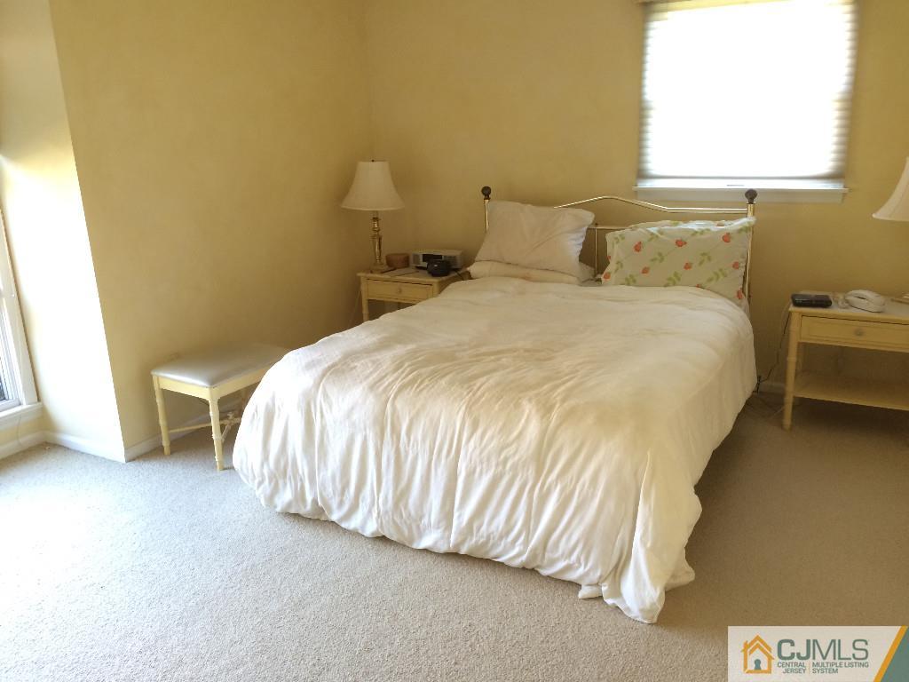 10 Carpender Road New Brunswick, NJ 08901 - Photo 13 of 25 a bed sitting in a bedroom next to a window