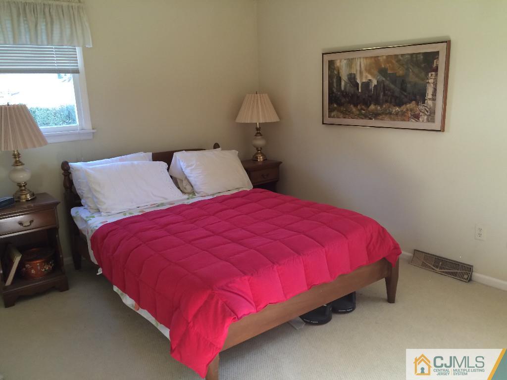 10 Carpender Road New Brunswick, NJ 08901 - Photo 16 of 25 a large bed sitting in a bedroom next to a window