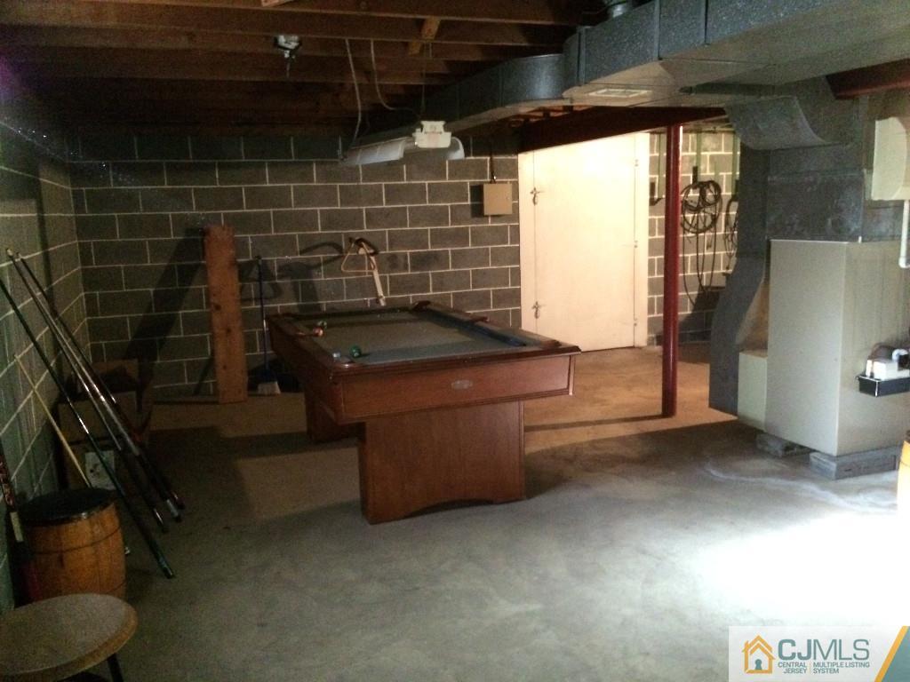 10 Carpender Road New Brunswick, NJ 08901 - Photo 19 of 25 a bathroom with a granite countertop sink a toilet and shower