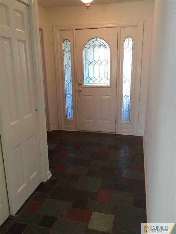 10 Carpender Road New Brunswick, NJ 08901 - Photo 3 of 25 an empty room with wooden floor mirror and windows
