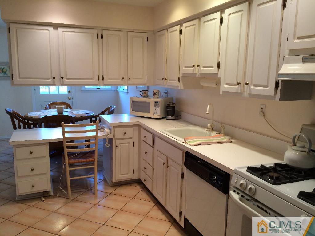 10 Carpender Road New Brunswick, NJ 08901 - Photo 4 of 25 a kitchen with stainless steel appliances a stove a sink and a refrigerator
