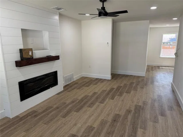 a kitchen with kitchen island granite countertop wooden cabinets and a sink
