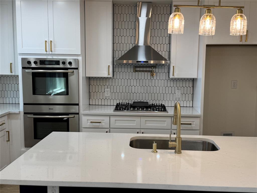 501 Cambridge Drive Richardson, TX 75080 - Photo 16 of 35 a kitchen with a stove a microwave and cabinets