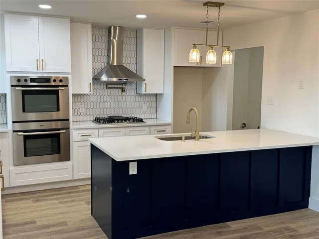 a stove top oven sitting inside of a kitchen