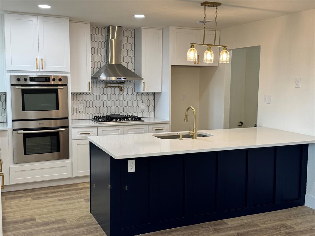501 Cambridge Drive Richardson, TX 75080 - Photo 17 of 35 a kitchen with stainless steel appliances granite countertop a sink stove and refrigerator