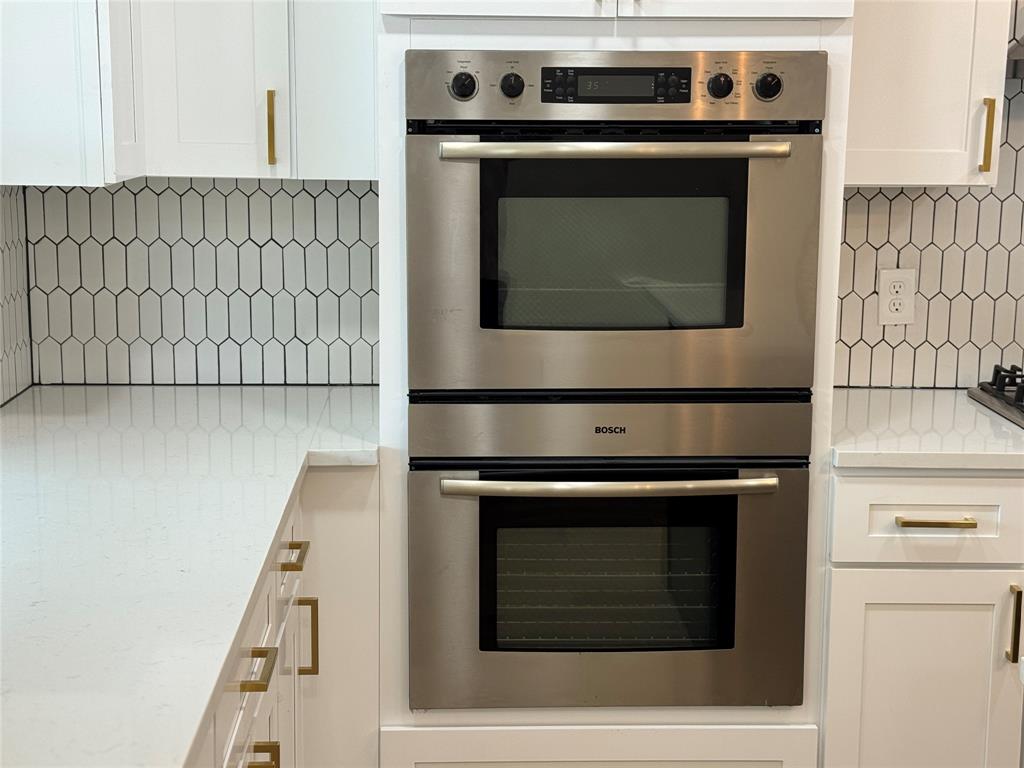 501 Cambridge Drive Richardson, TX 75080 - Photo 18 of 35 a stove top oven sitting inside of a kitchen