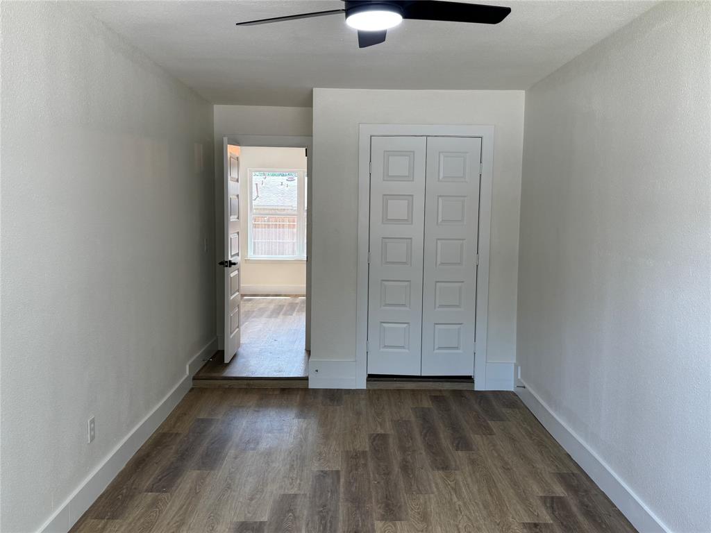 501 Cambridge Drive Richardson, TX 75080 - Photo 22 of 35 an empty room with wooden floor cabinet and windows