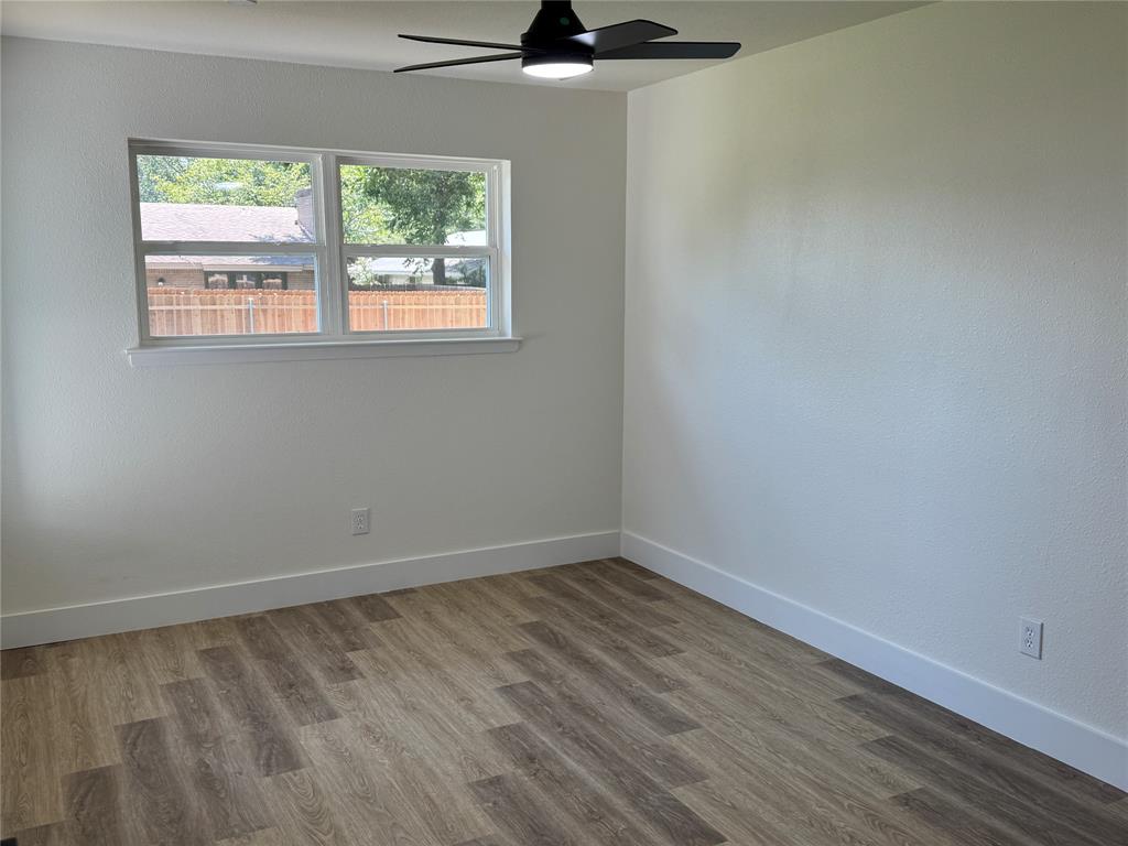501 Cambridge Drive Richardson, TX 75080 - Photo 24 of 35 wooden floor in an empty room with a window