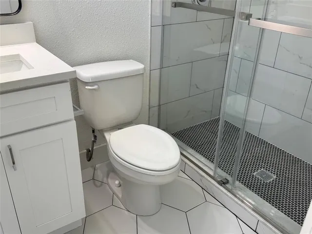 a bathroom with a toilet and shower