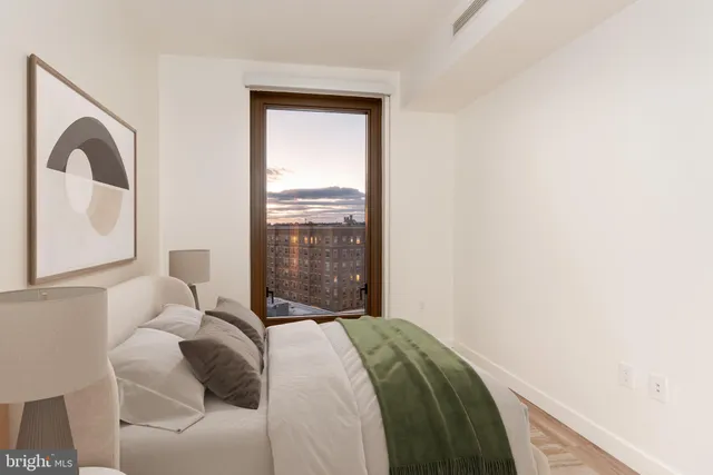 a bedroom with a bed and a mirror