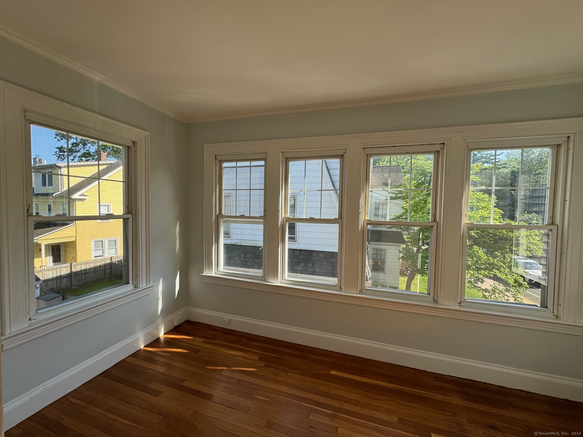 1253 Forest Road, Unit 2 New Haven, CT 06515 - Photo 12 of 30 a view of an empty room with wooden floor and a window