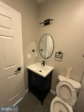 a bathroom with a toilet a sink and a mirror