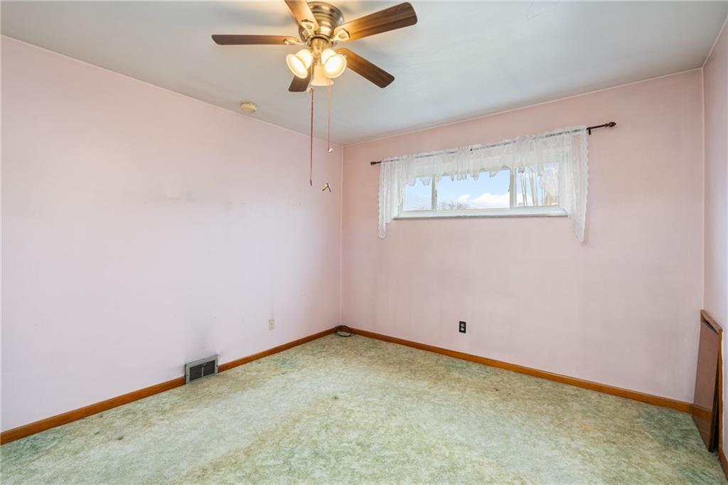49 Gordon Street McKees Rocks, PA 15136 - Photo 15 of 27 an empty room with a window and a fan