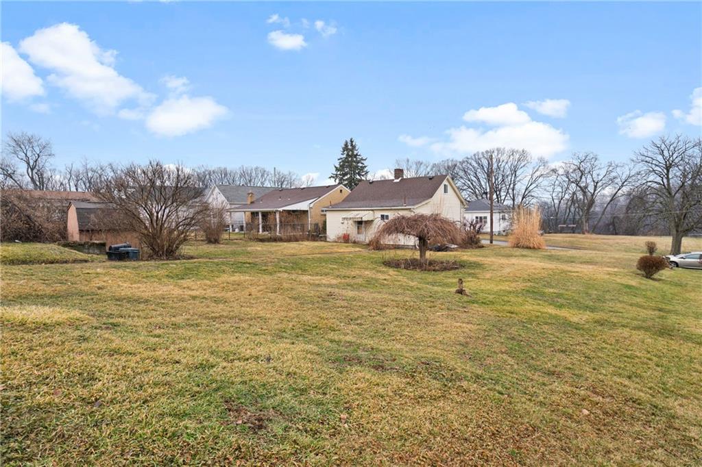 49 Gordon Street McKees Rocks, PA 15136 - Photo 25 of 27 a house view with swimming pool and trees in the background