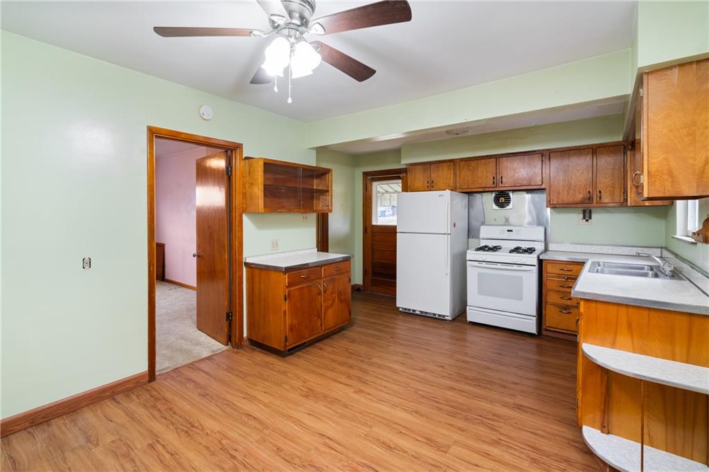 49 Gordon Street McKees Rocks, PA 15136 - Photo 9 of 27 a kitchen with stainless steel appliances a refrigerator and a stove top oven