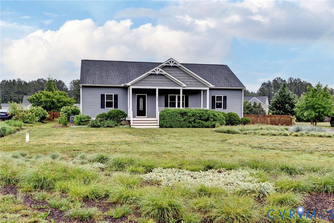 8904 Rock Cedar Road New Kent, VA 23124 - Photo 35 of 37 a front view of a house with a garden