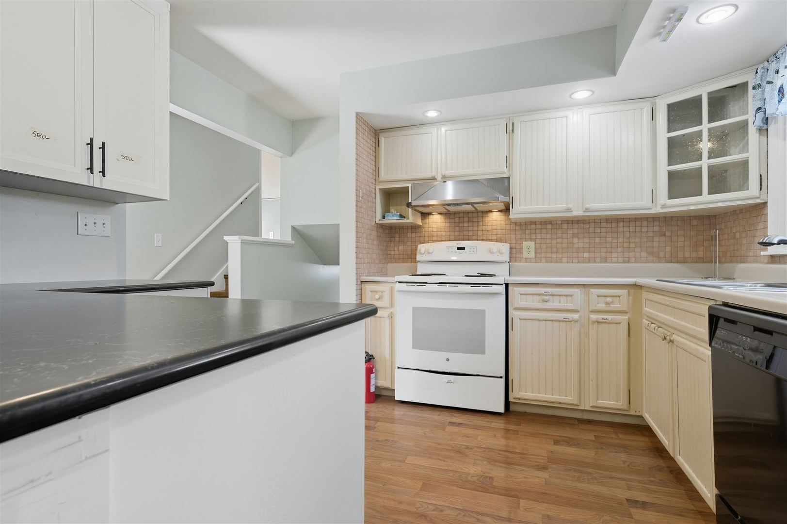 402 Bradley Lane Normal, IL 61761 - Photo 13 of 24 a kitchen with white cabinets stainless steel appliances and sink
