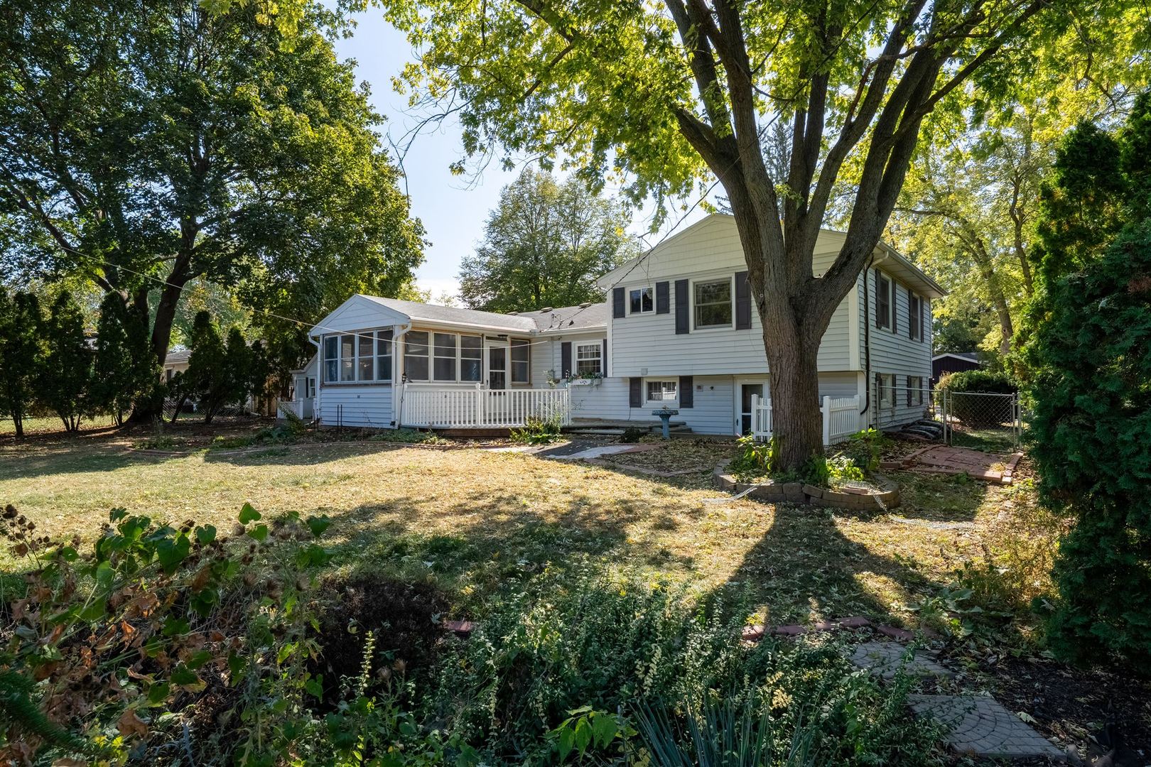 402 Bradley Lane Normal, IL 61761 - Photo 7 of 24 a view of a house with large trees and a yard