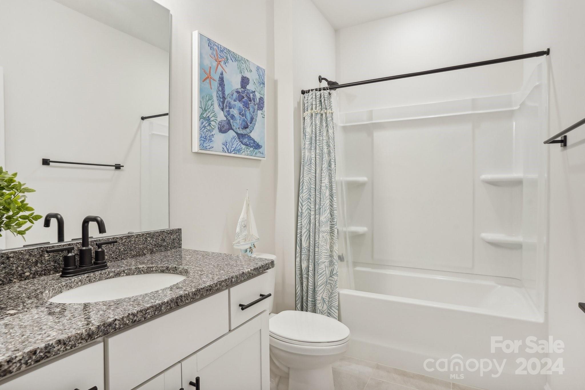 4203 Millstream Road Denver, NC 28037 - Photo 15 of 31 a bathroom with a granite countertop sink toilet and shower