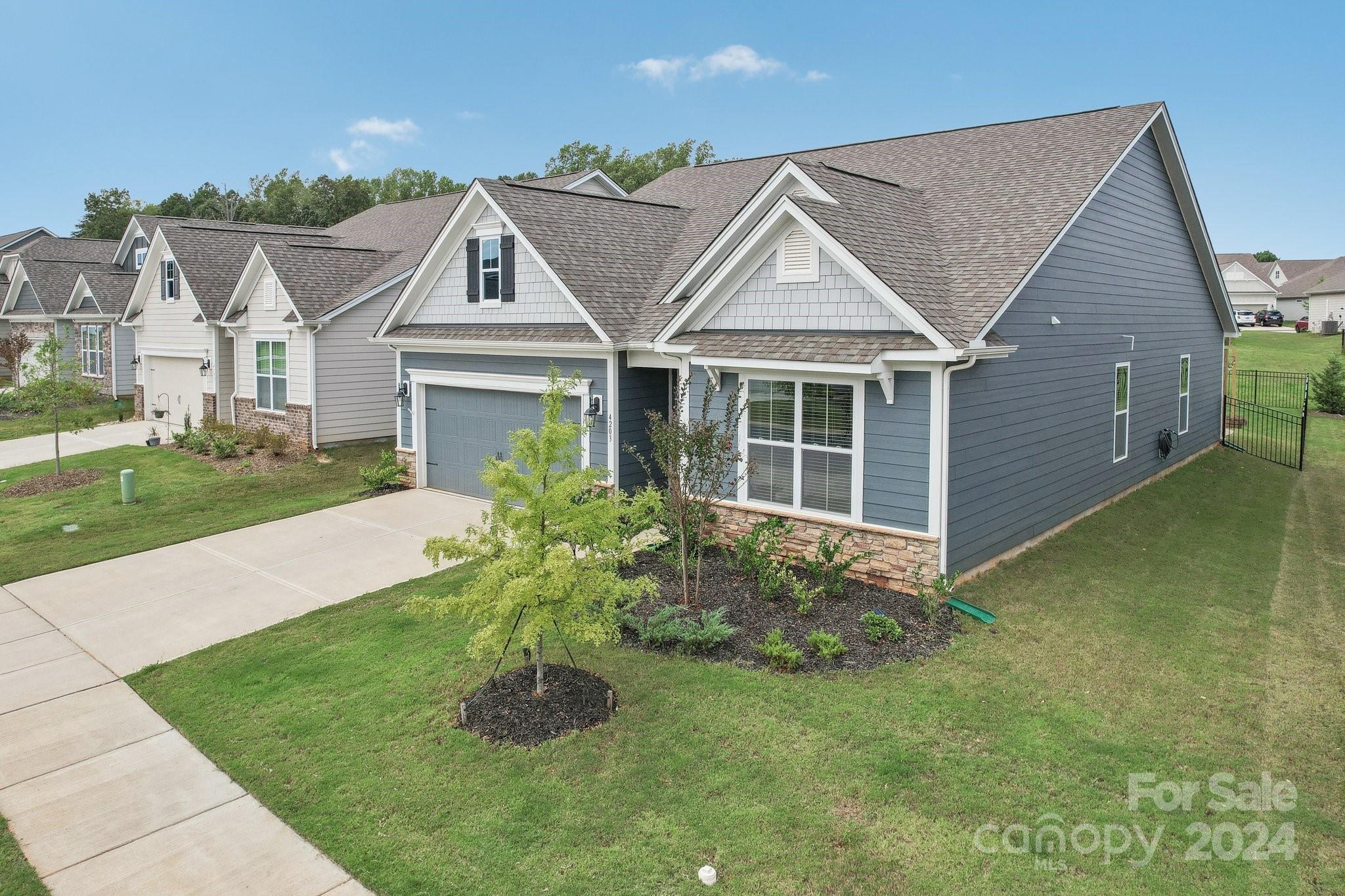 4203 Millstream Road Denver, NC 28037 - Photo 2 of 31 a view of a house with a garden