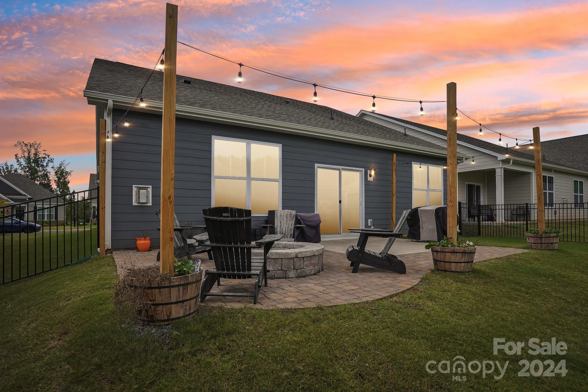 4203 Millstream Road Denver, NC 28037 - Photo 25 of 31 a view of a patio with table and chairs potted plants and floor to ceiling window