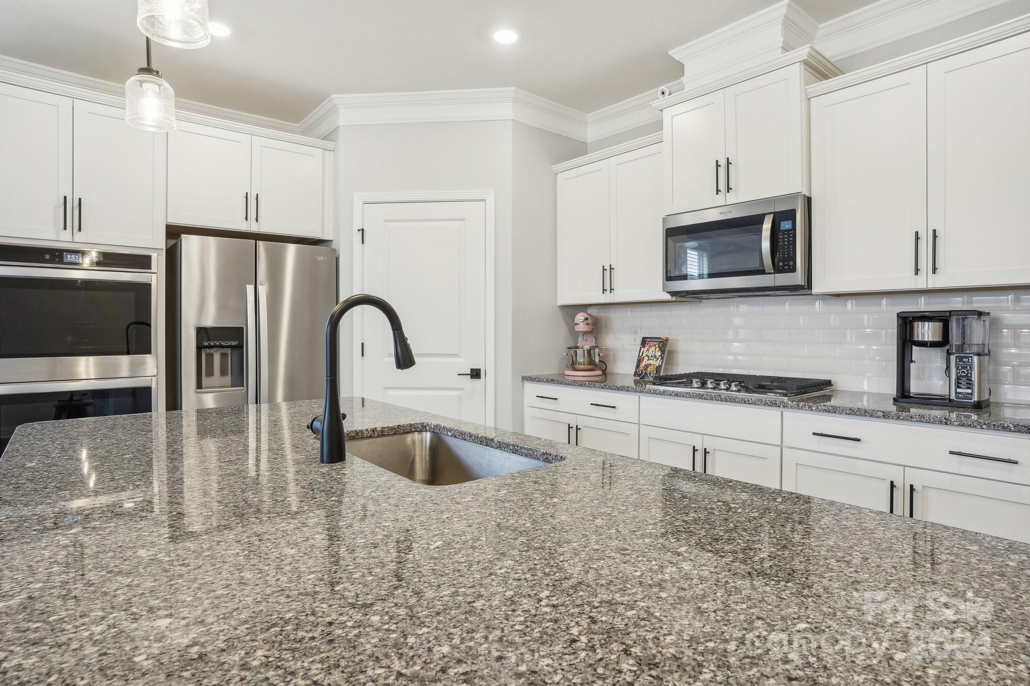 4203 Millstream Road Denver, NC 28037 - Photo 8 of 31 a kitchen with stainless steel appliances granite countertop a stove a sink and a microwave