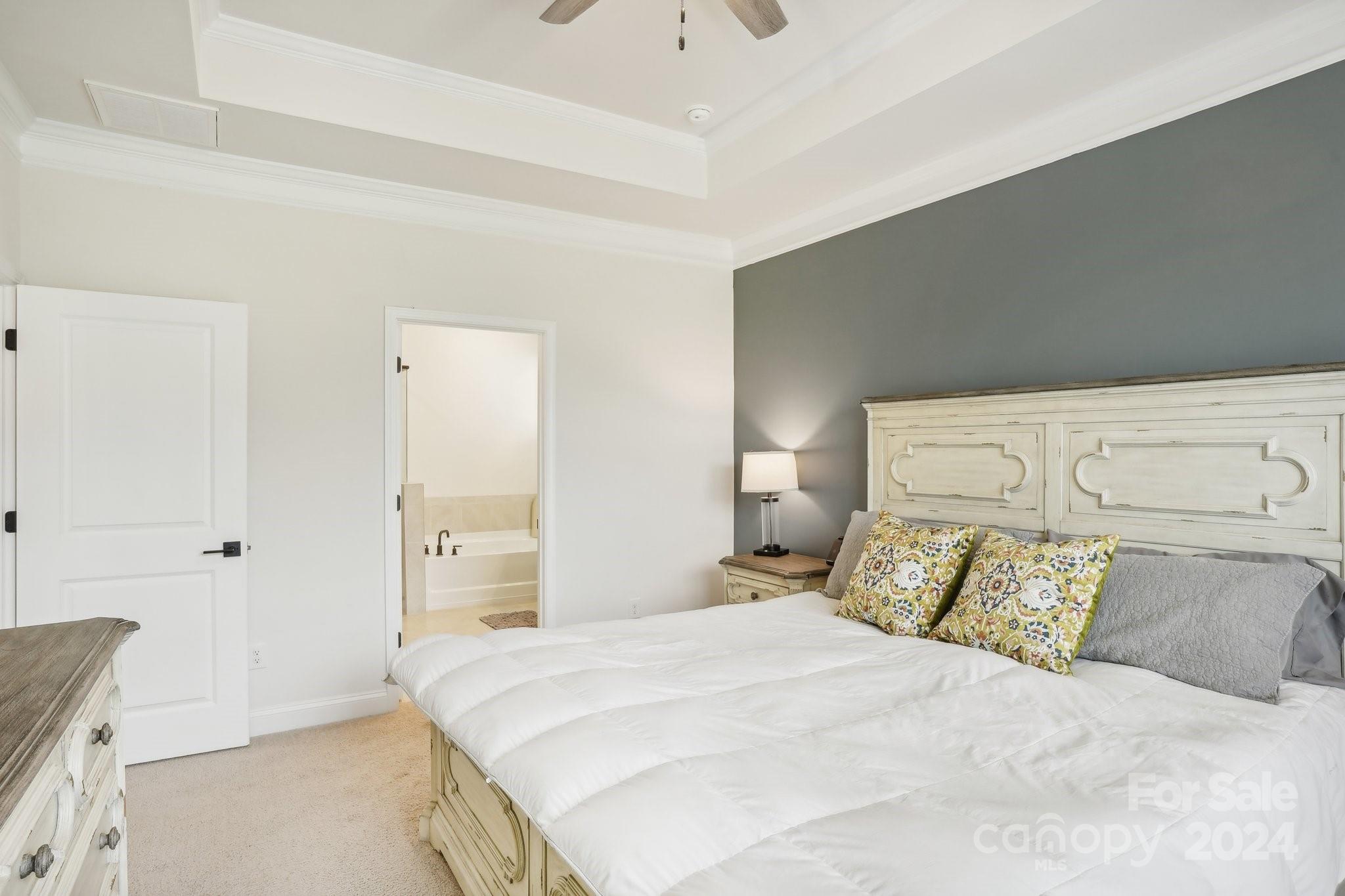 4203 Millstream Road Denver, NC 28037 - Photo 10 of 31 a bedroom with a bed and a chandelier