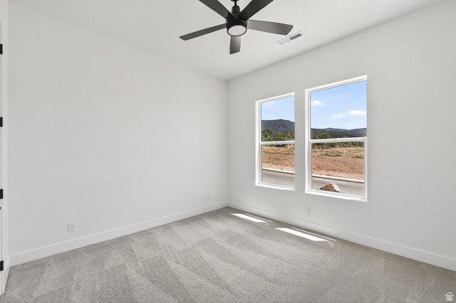 2862 South Mountain Rnch Road Cedar City, UT 84720 - Photo 34 of 64 Interior room featuring a contemporary ceiling fan, two large windows, light gray carpeting, crisp white walls, and bright white baseboards