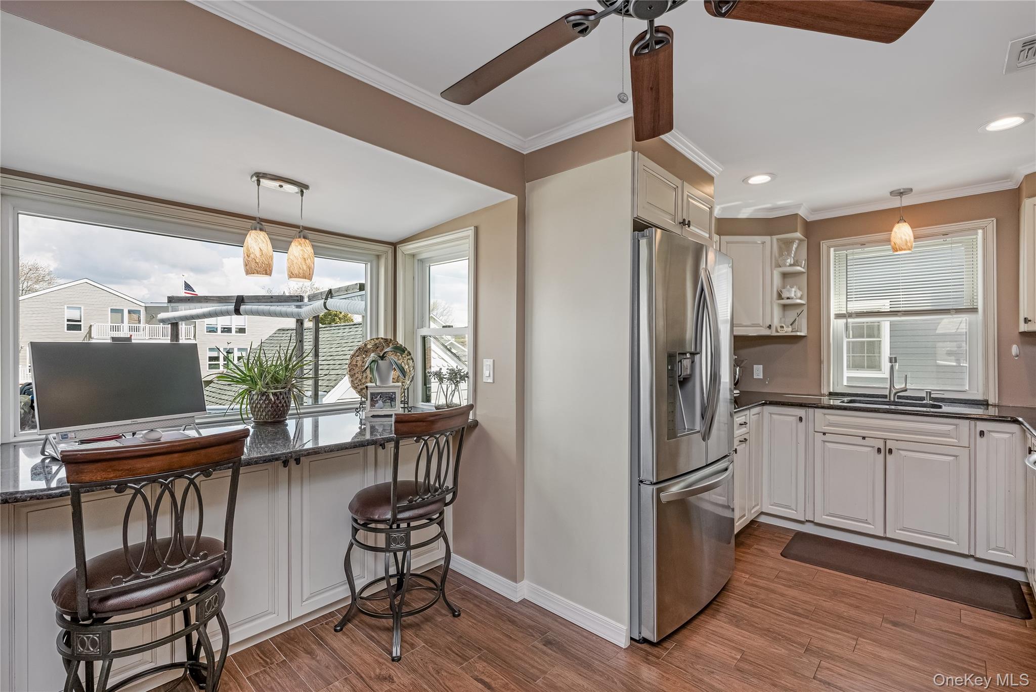 25 Cape Road Amityville, NY 11701 - Photo 11 of 30 a kitchen with stainless steel appliances granite countertop a refrigerator and a stove top oven