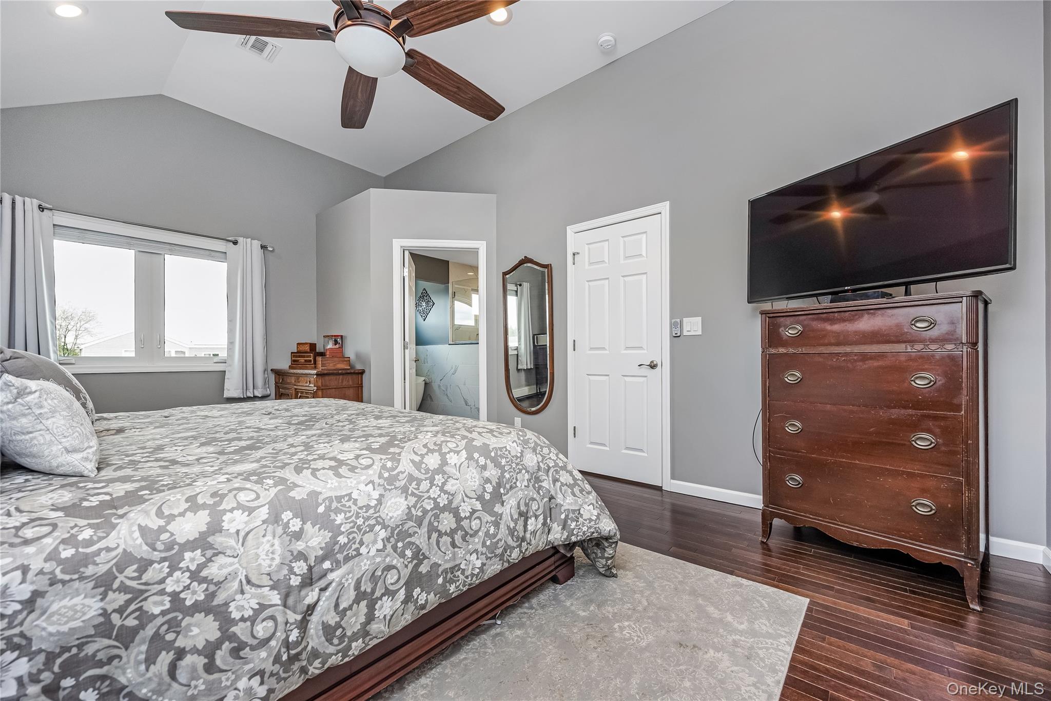 25 Cape Road Amityville, NY 11701 - Photo 15 of 30 a bedroom with a bed and a flat screen tv