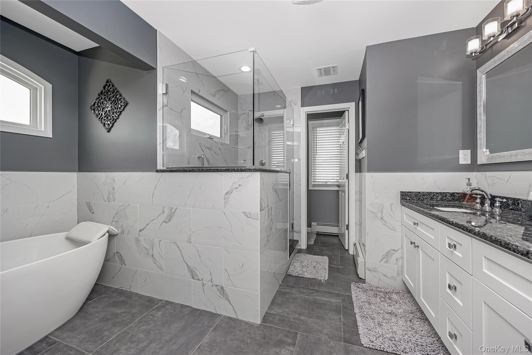 25 Cape Road Amityville, NY 11701 - Photo 17 of 30 a bathroom with a granite countertop sink mirror and bathtub
