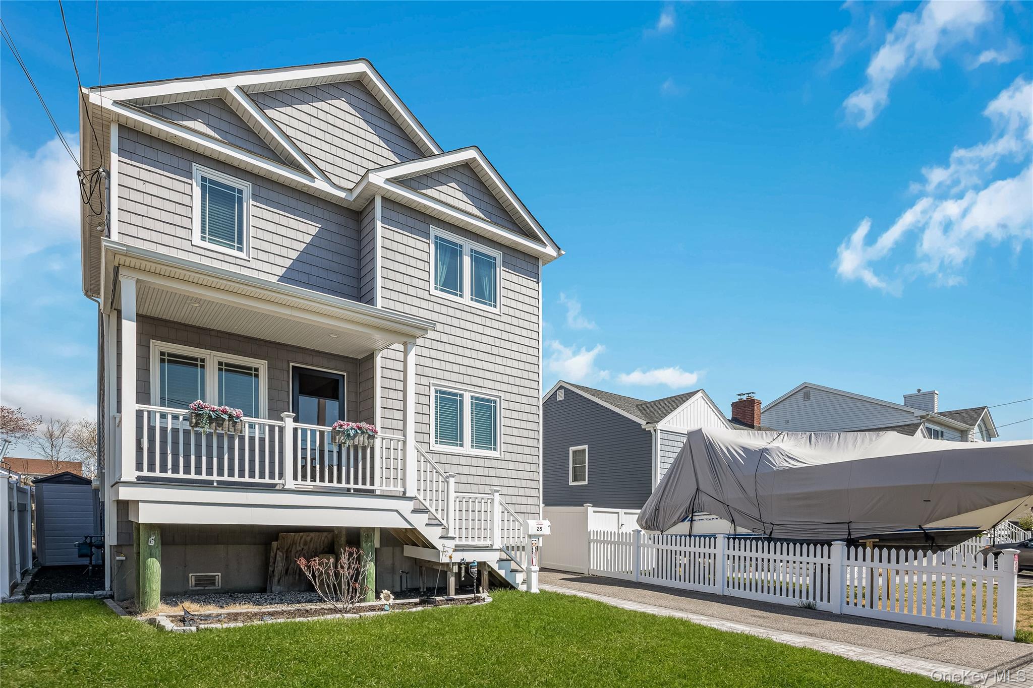25 Cape Road Amityville, NY 11701 - Photo 2 of 30 a front view of a house with a yard