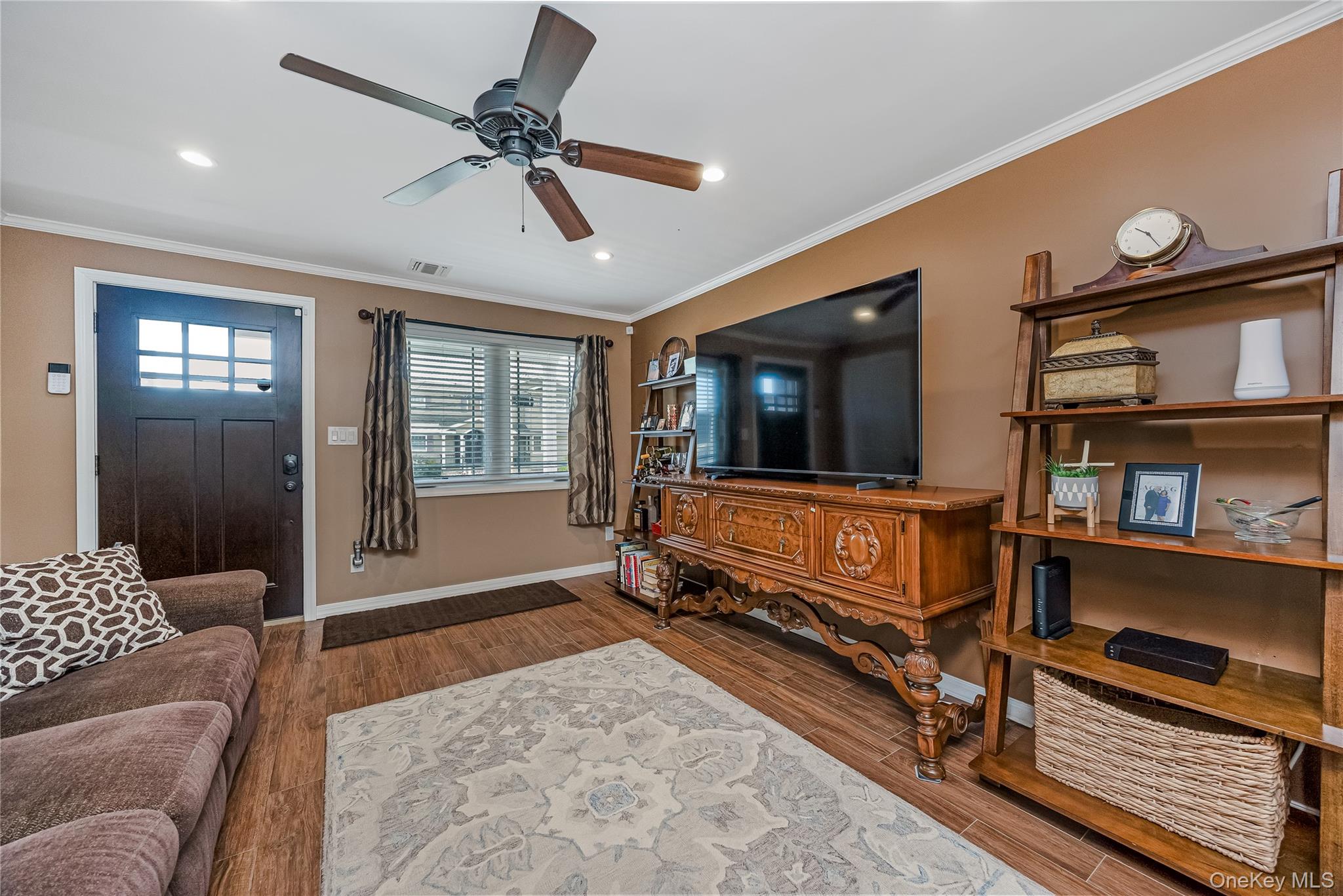 25 Cape Road Amityville, NY 11701 - Photo 4 of 30 a living room with furniture and a flat screen tv