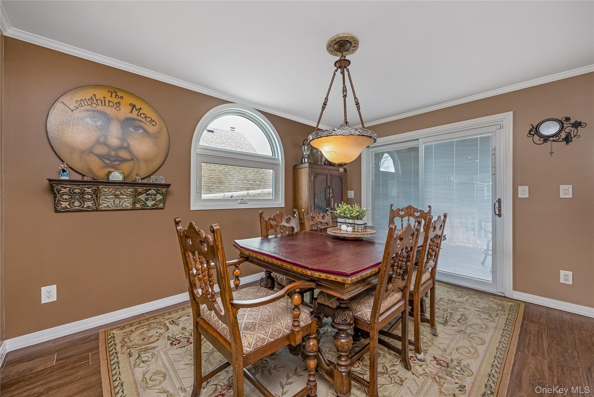 25 Cape Road Amityville, NY 11701 - Photo 8 of 30 a view of a dining room with furniture and a chandelier