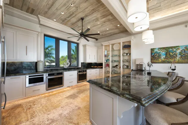 a bathroom with a granite countertop sink and a large mirror