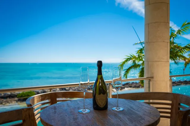 a white toilet sitting next to a white wall