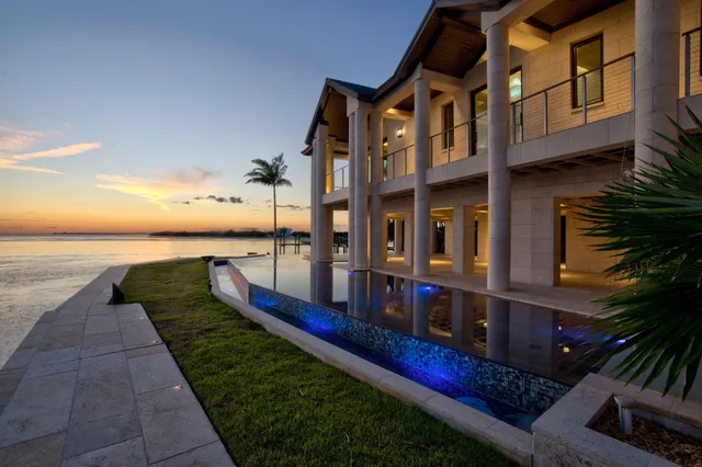 a view of a house with a small yard and a garden