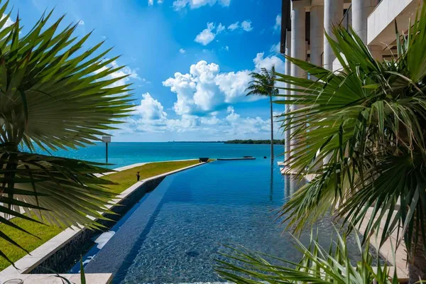 a view of a house with a big yard and large trees