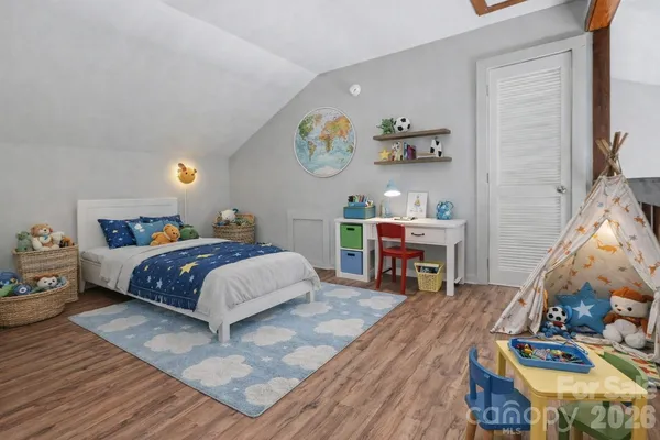 a bedroom with a bed and a chandelier