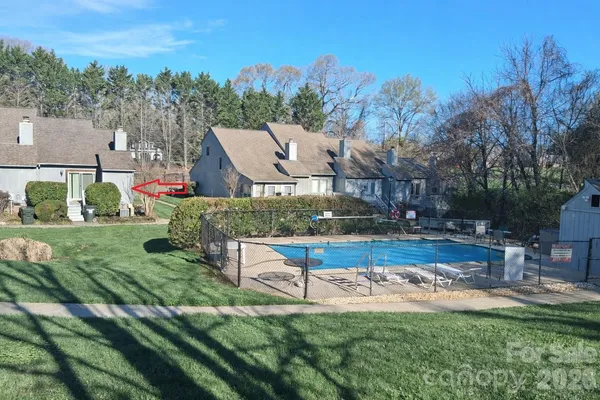 an aerial view of a house with swimming pool garden and fire pit