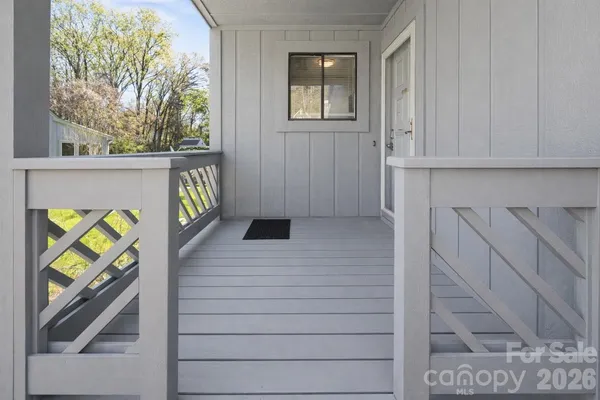 a view of an entryway with wooden floor and door