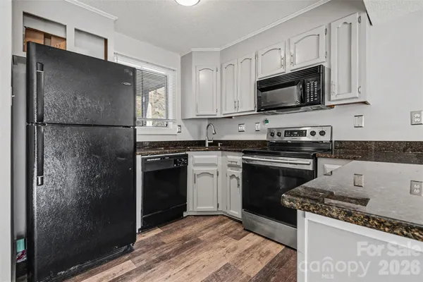 a kitchen with a refrigerator stove and microwave