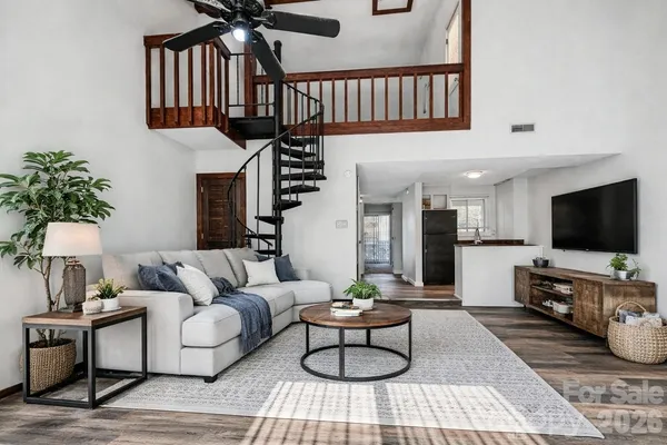 a living room with furniture a rug and a flat screen tv