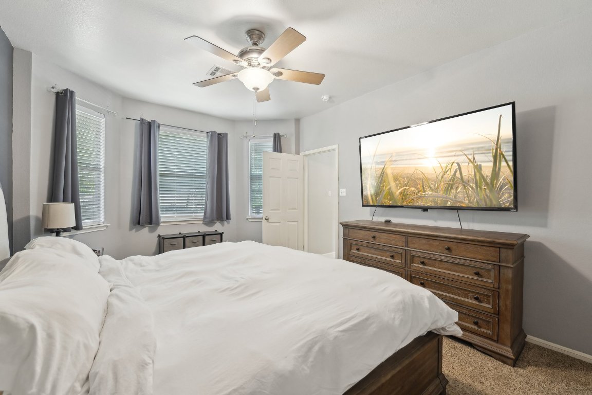 504 Chaparral Drive Leander, TX 78641 - Photo 13 of 34 a bedroom with a bed and a flat screen tv