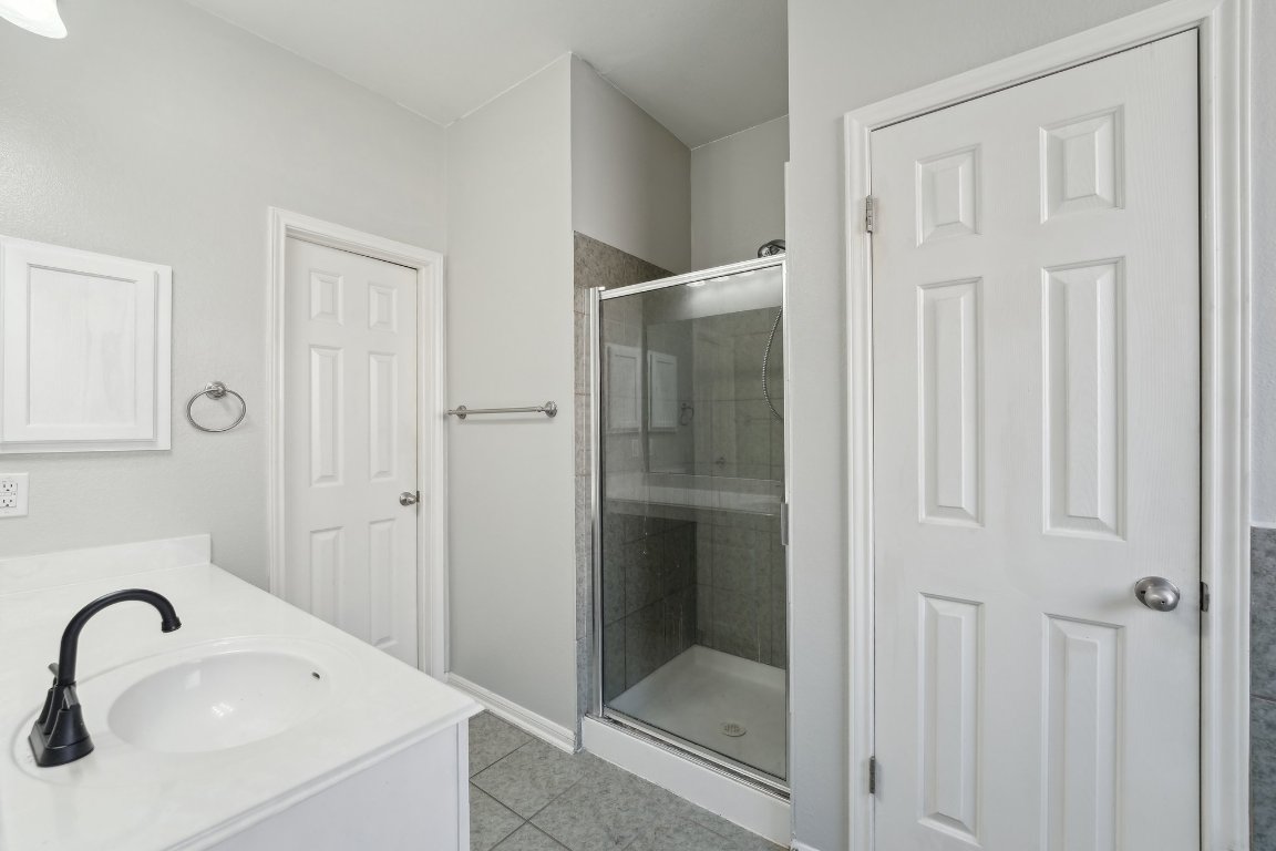 504 Chaparral Drive Leander, TX 78641 - Photo 15 of 34 a bathroom with a sink and shower